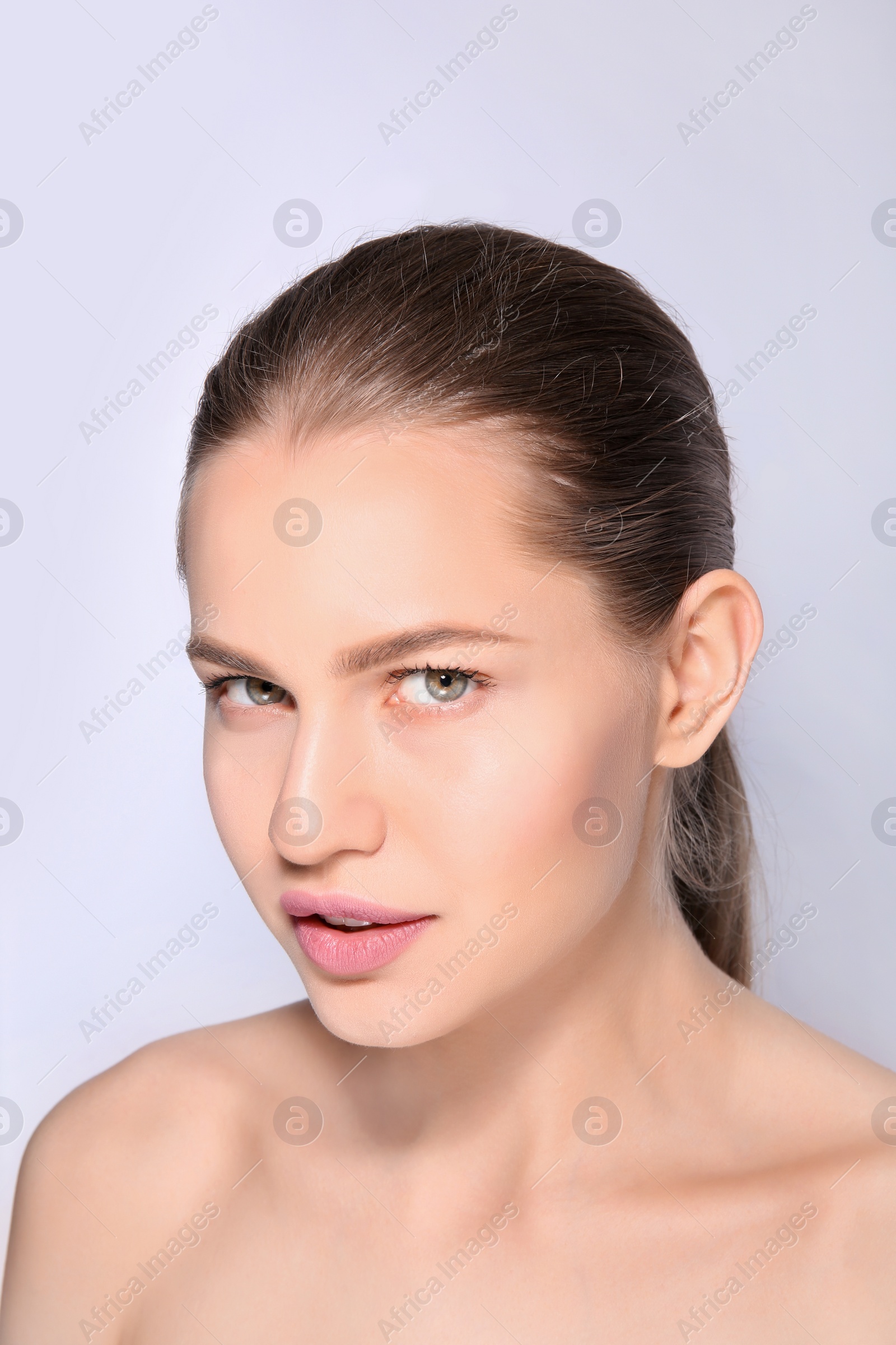 Photo of Beautiful woman with perfect eyebrows on light background