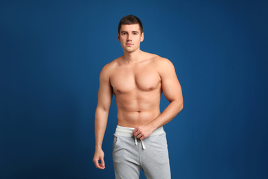 Photo of Man with sexy body on blue background