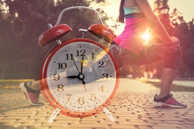Image of Workout time. Double exposure of woman doing exercise on sunny morning outdoors and alarm clock