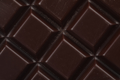 Photo of Delicious dark chocolate as background, closeup view