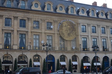 Photo of Paris, France - December 10, 2022: Van Cleef & Arpels. Piaget and Chanel stores exterior with Christmas decor