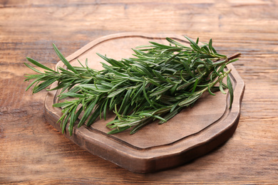 Photo of Bunch of fresh rosemary on wooden table