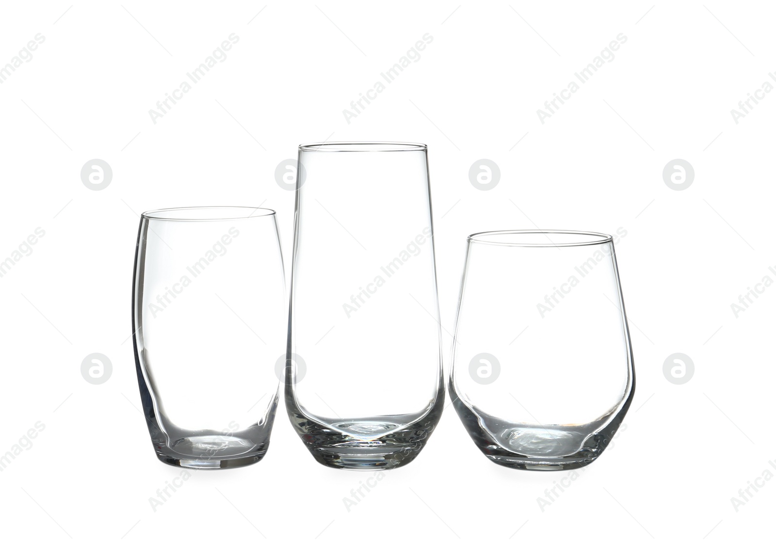 Photo of Set of different clean empty glasses isolated on white