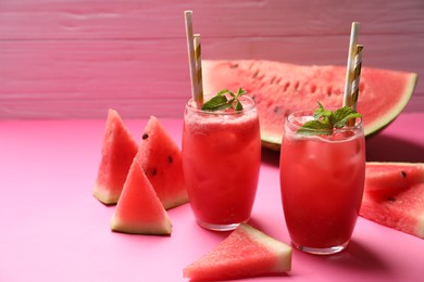 Tasty watermelon drink with mint on pink background