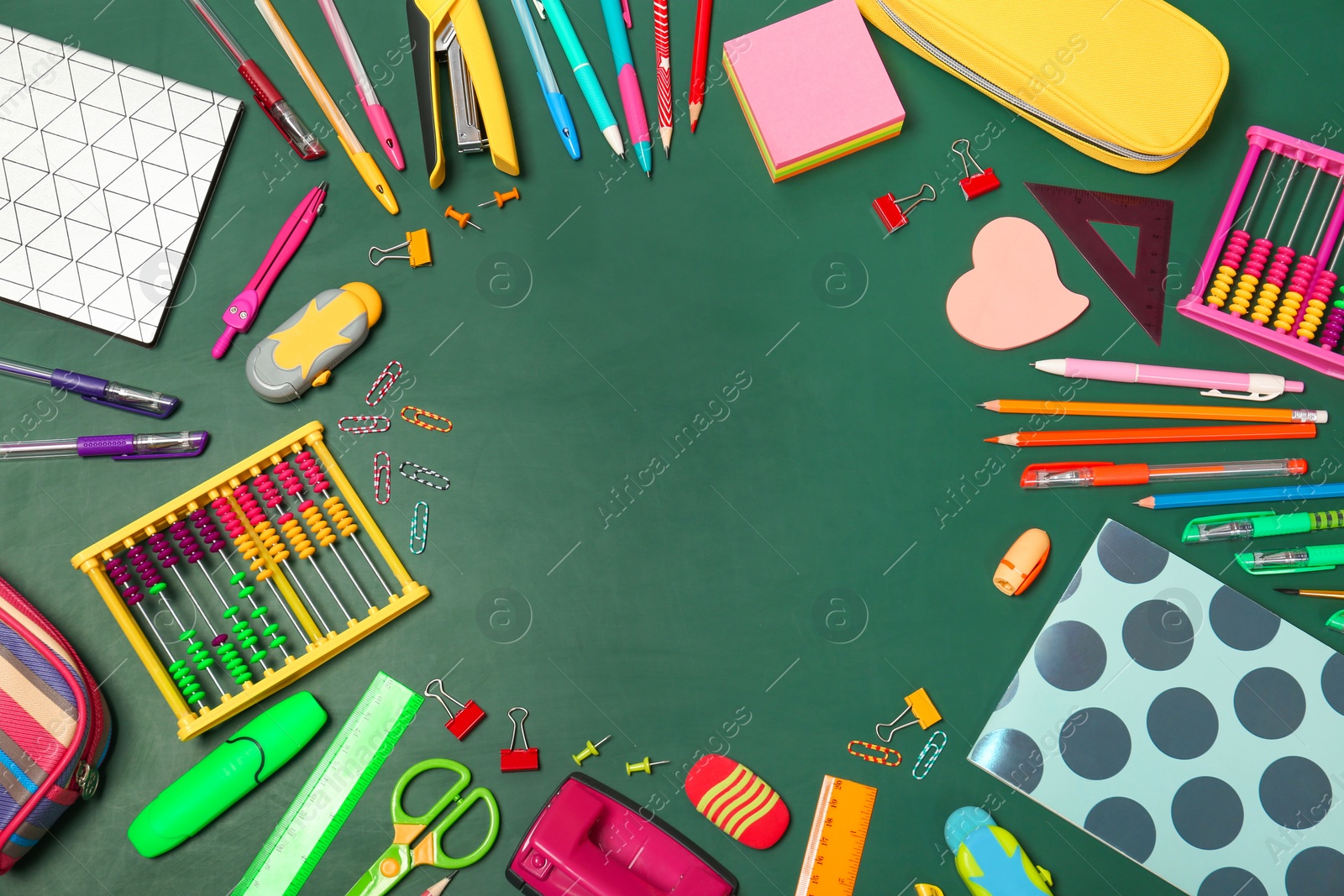 Photo of Flat lay composition with different school stationery on chalkboard surface