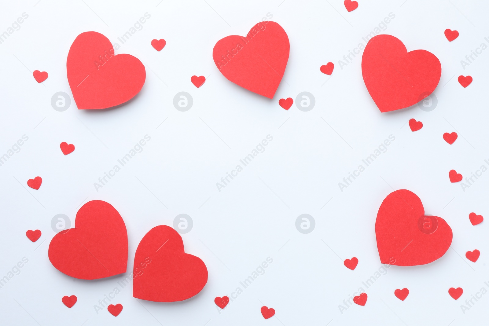 Photo of Frame of beautiful red paper hearts on white background, flat lay. Space for text