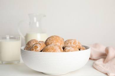 Photo of Tasty homemade gingerbread cookies in bowl on white table