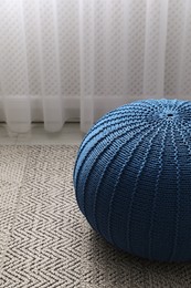 Photo of Stylish blue pouf on floor in room