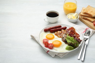 Delicious breakfast with sunny side up eggs served on white table. Space for text