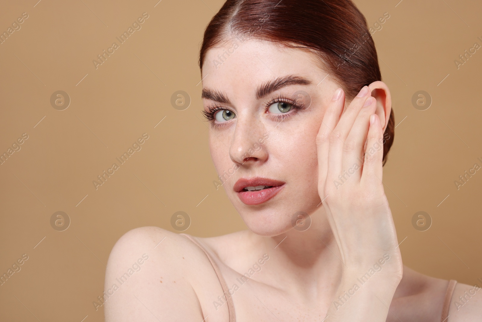 Photo of Portrait of beautiful woman on beige background, closeup