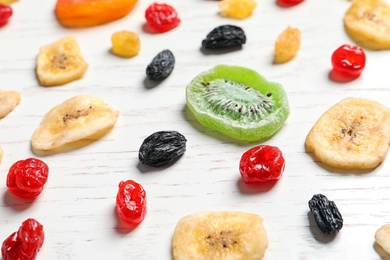 Photo of Different dried fruits on wooden background, closeup. Healthy lifestyle