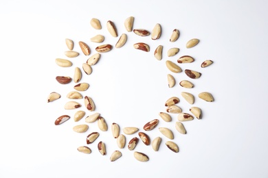 Composition with Brazil nuts and space for text on white background, top view