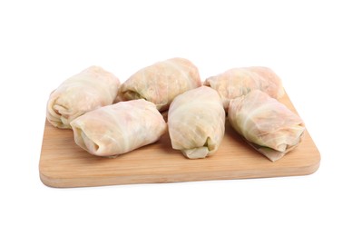 Photo of Wooden board with uncooked stuffed cabbage rolls on white background