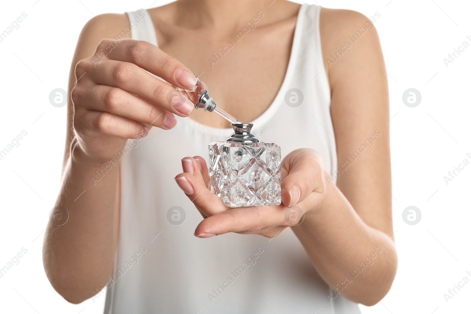 Photo of Young woman applying perfume on white background, closeup