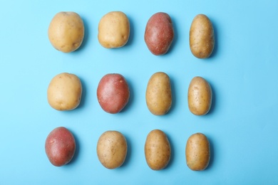 Photo of Flat lay composition with fresh organic potatoes on color background