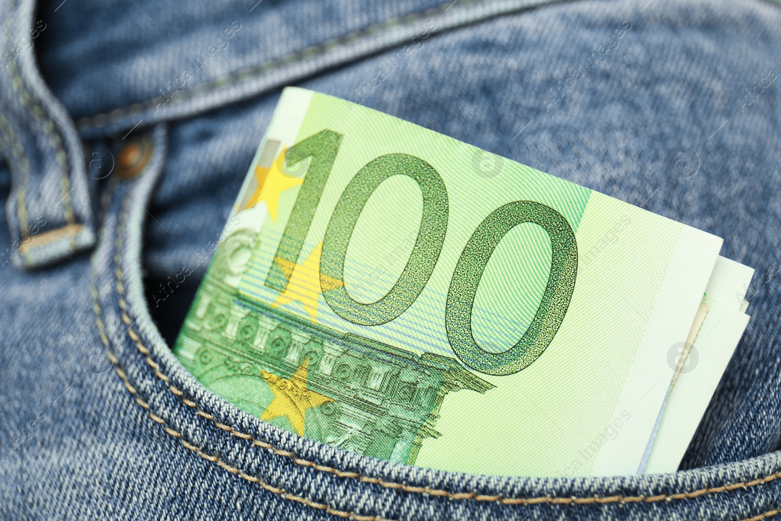 Photo of Euro banknotes in pocket of jeans, closeup