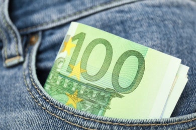 Photo of Euro banknotes in pocket of jeans, closeup