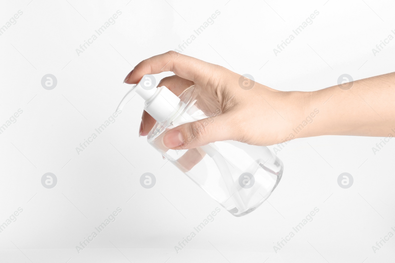 Photo of Woman holding antiseptic gel on white background, closeup