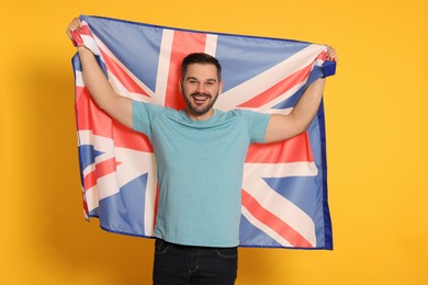 Photo of Man with flag of United Kingdom on yellow background