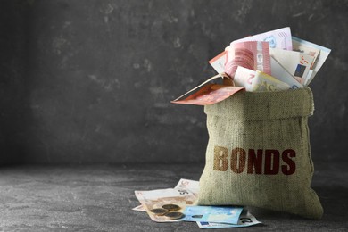 Image of Eurobonds concept. Sack full of money on grey table, space for text