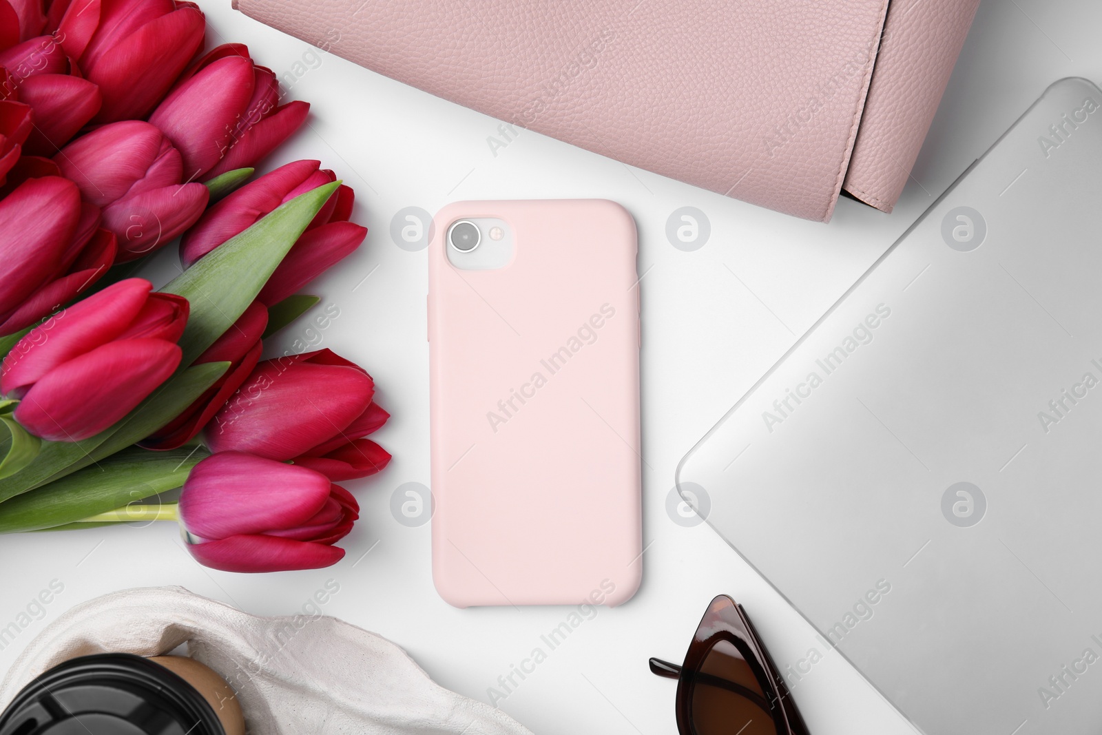 Photo of Flat lay composition with beautiful tulips and laptop on white table