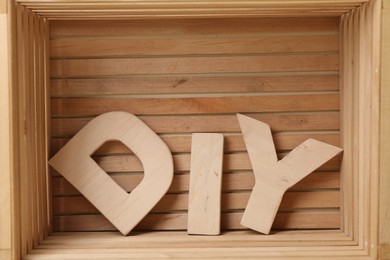 Photo of Abbreviation DIY made of letters in wooden crate
