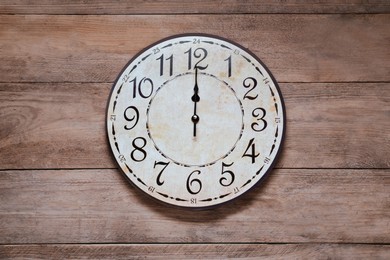 Stylish round clock on wooden table, top view. Interior element