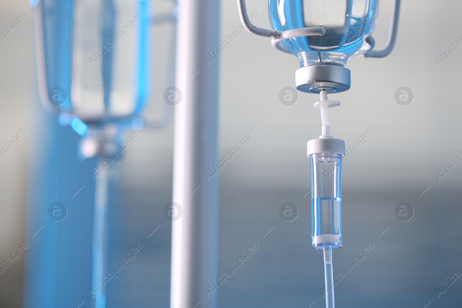 Photo of IV drip against blurred background, space for text