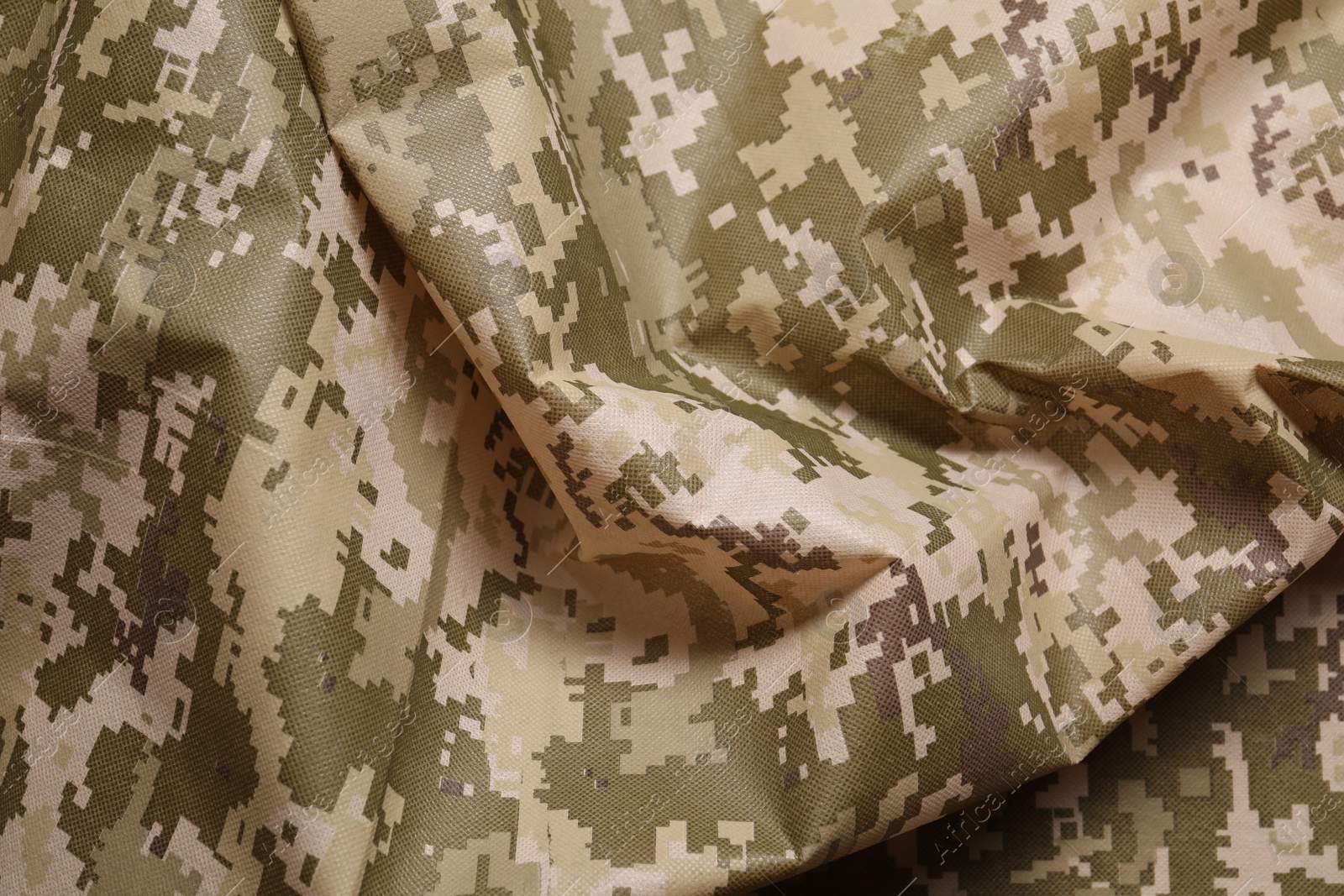 Photo of Texture of crumpled camouflage fabric as background, top view