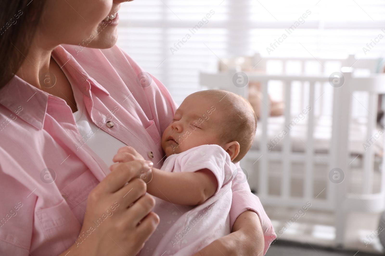 Photo of Young woman with her little baby at home, closeup. Space for text