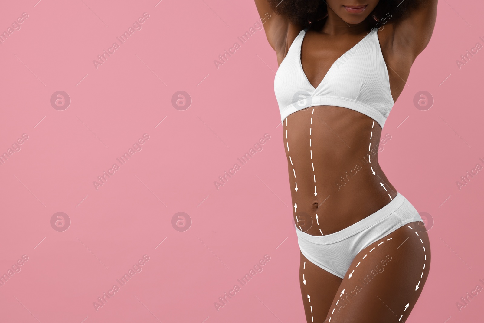 Image of Woman showing her beautiful figure on pink background, closeup. Space for text. Cosmetic treatment lines on her body