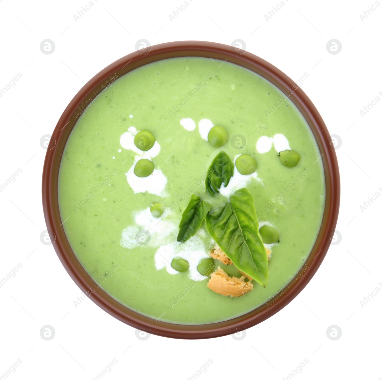 Photo of Bowl with green pea soup on white background, top view