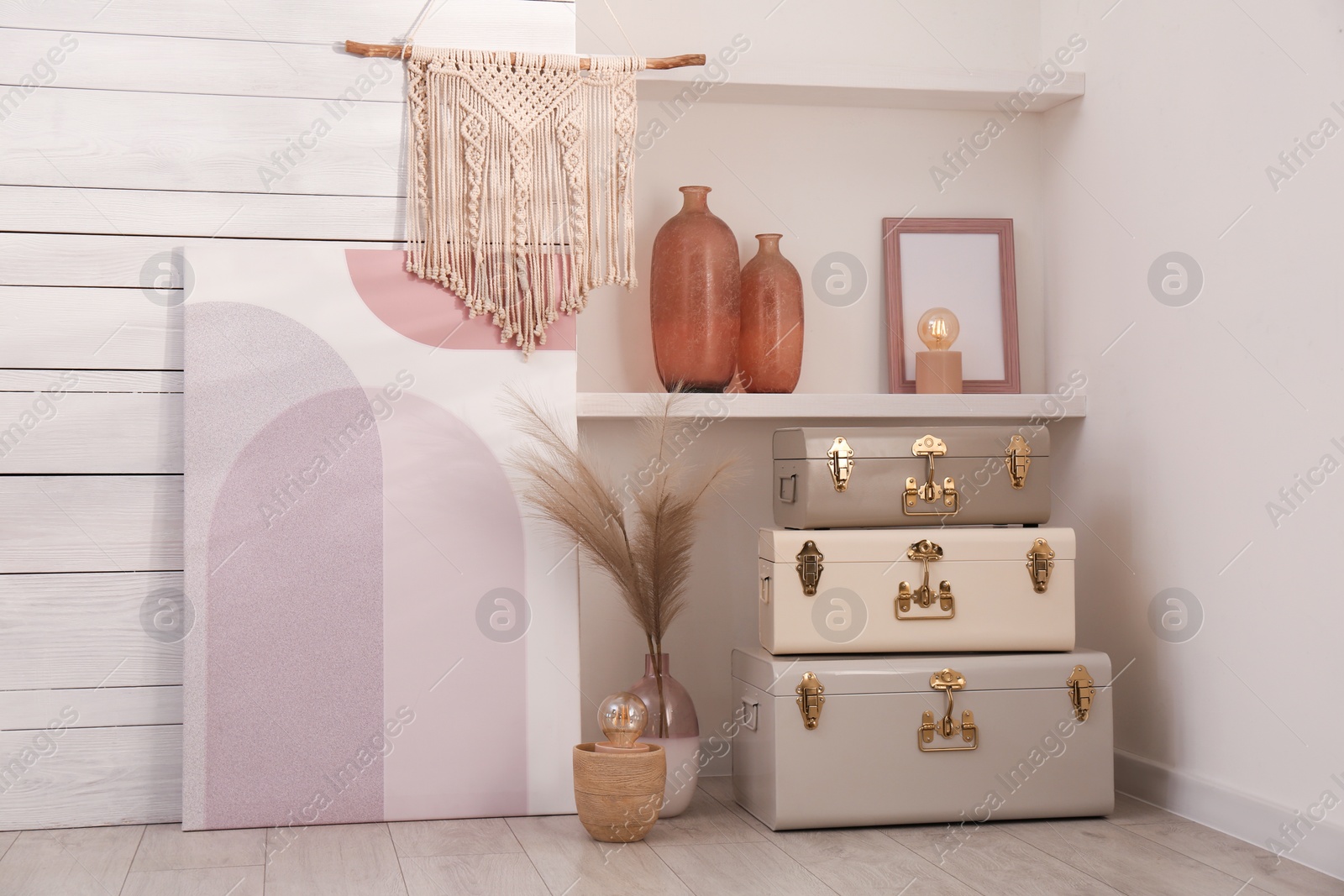 Photo of Stylish storage trunks and different decor elements near white wall indoors. Interior design