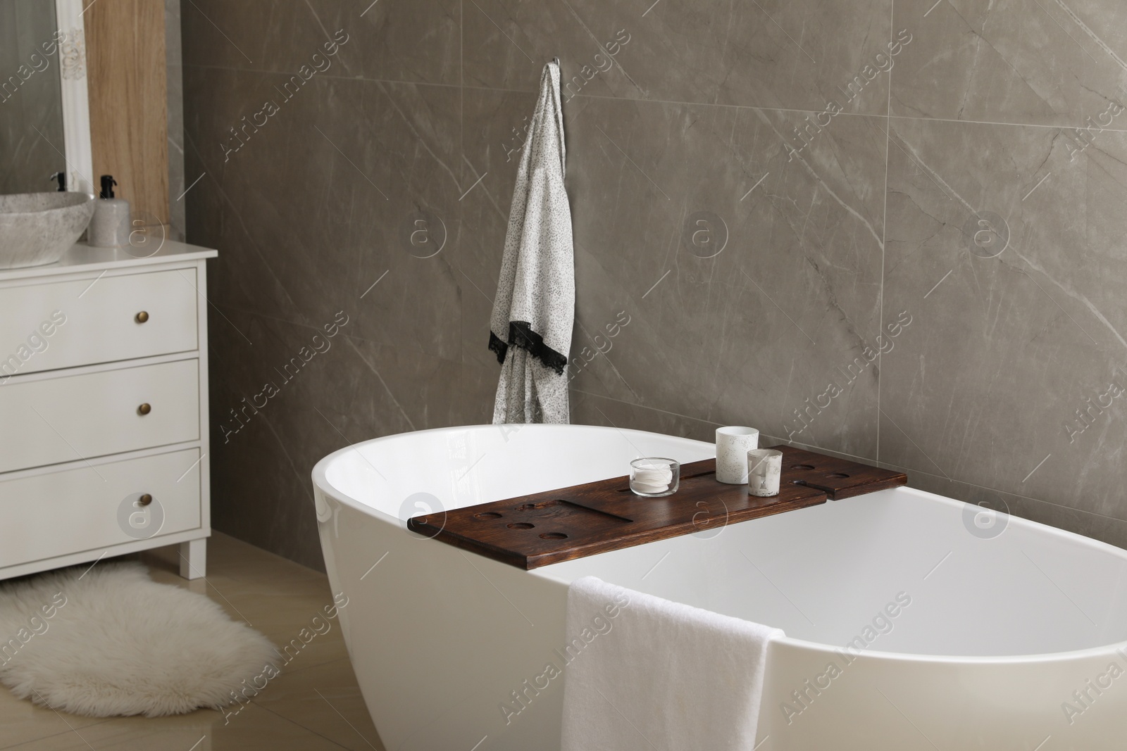 Photo of Modern white tub in bathroom. Interior design