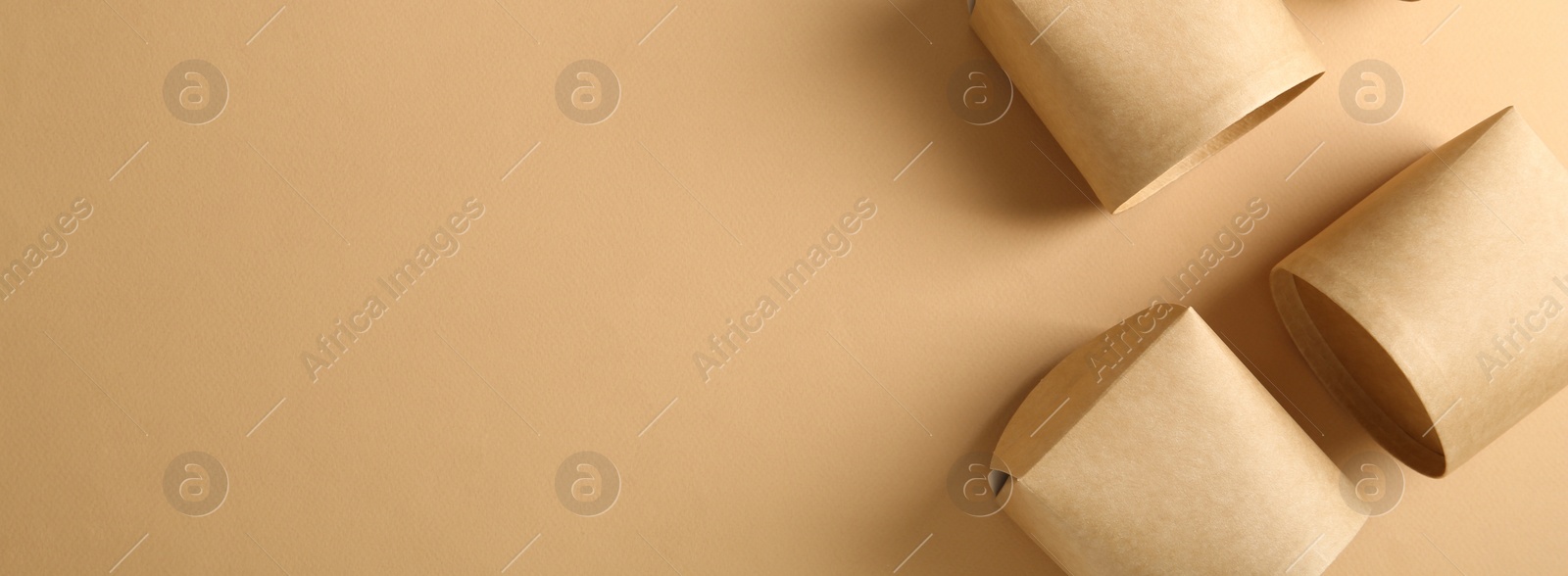Image of Eco friendly food containers on beige background, flat lay with space for text. Banner design