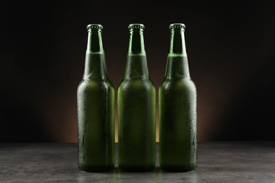 Photo of Many bottles of beer on grey table