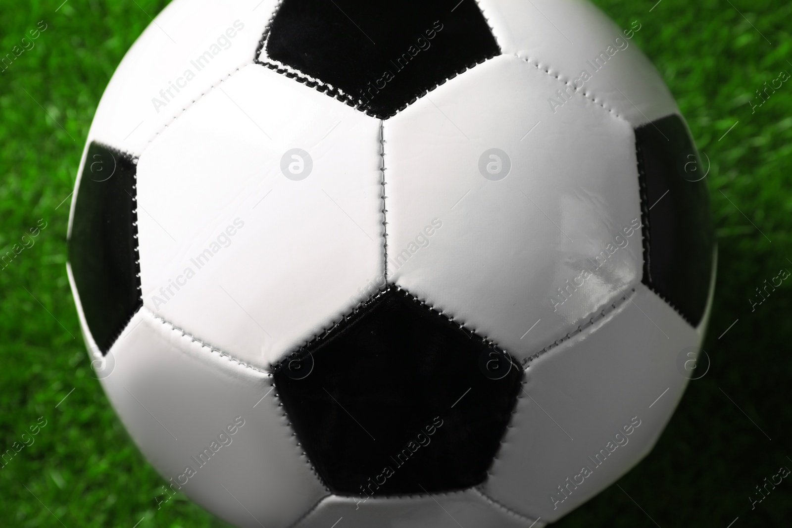 Photo of One soccer ball on green grass, closeup. Sports equipment