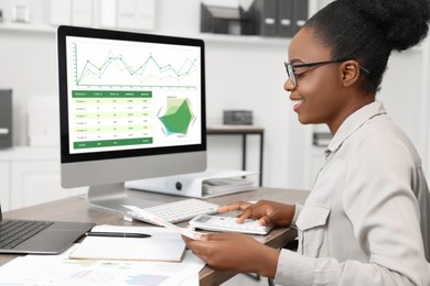 Photo of Professional accountant working at wooden desk in office