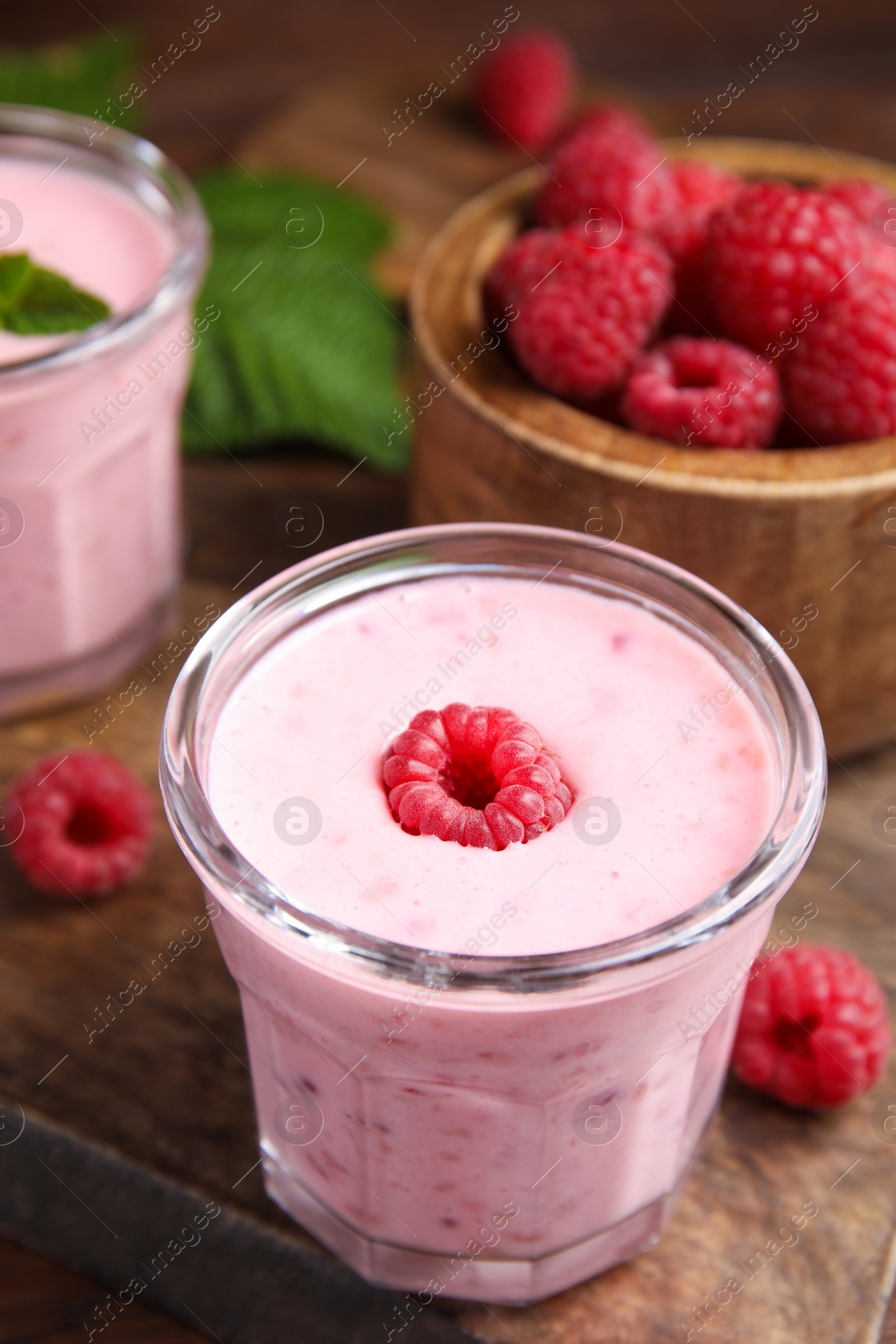 Photo of Tasty fresh raspberry smoothie on wooden table