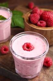 Photo of Tasty fresh raspberry smoothie on wooden table