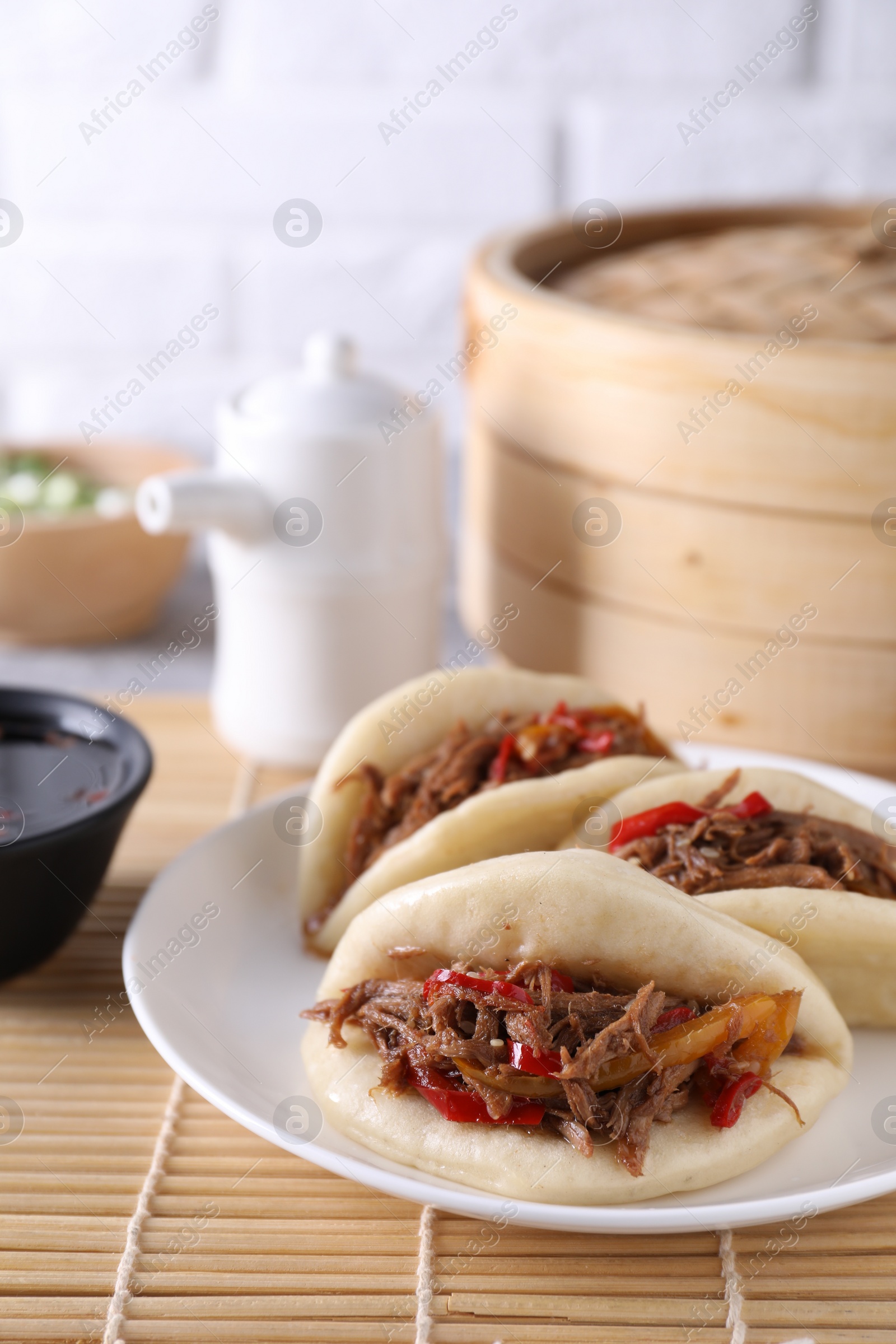 Photo of Plate with delicious gua bao (pork belly buns) on table, closeup