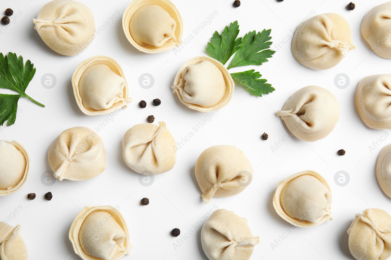 Photo of Composition with raw dumplings on white background, top view. Home cooking