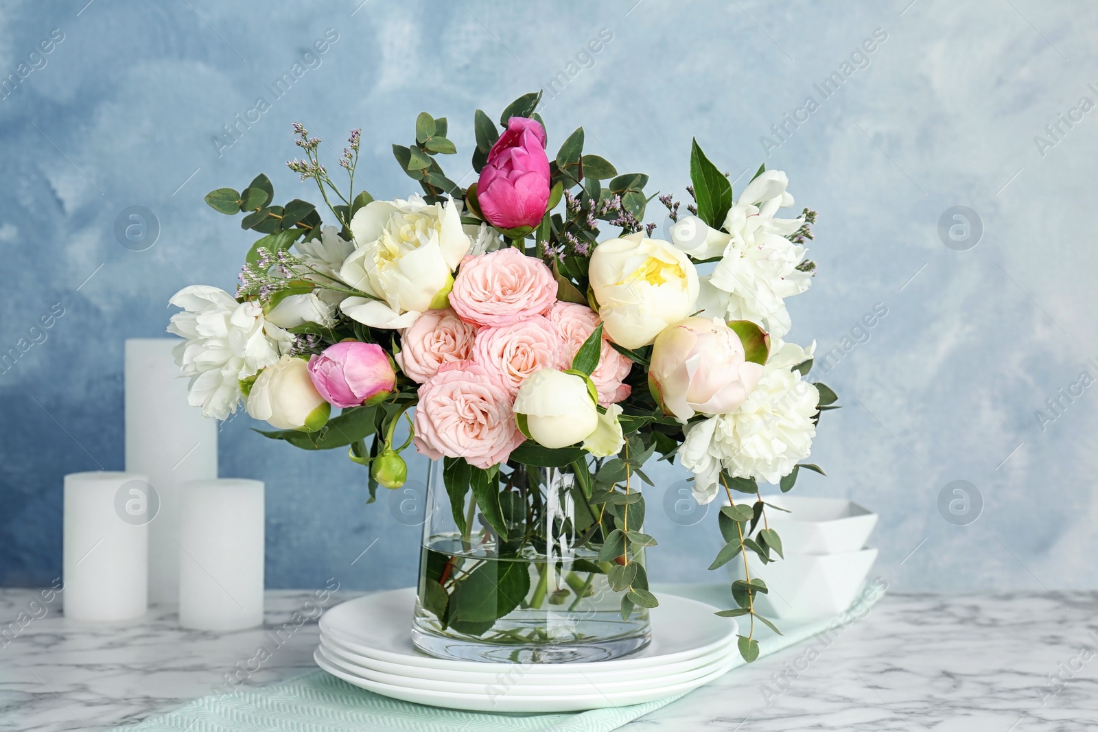 Photo of Vase with bouquet of beautiful flowers on table