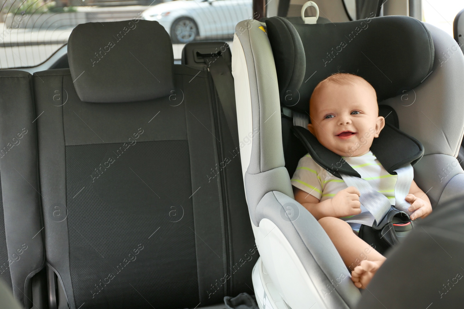 Photo of Little baby in child safety seat inside of car