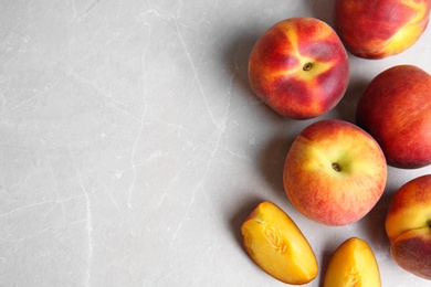 Fresh juicy peaches on marble table, top view with space for text