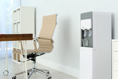 Modern water cooler in stylish office interior