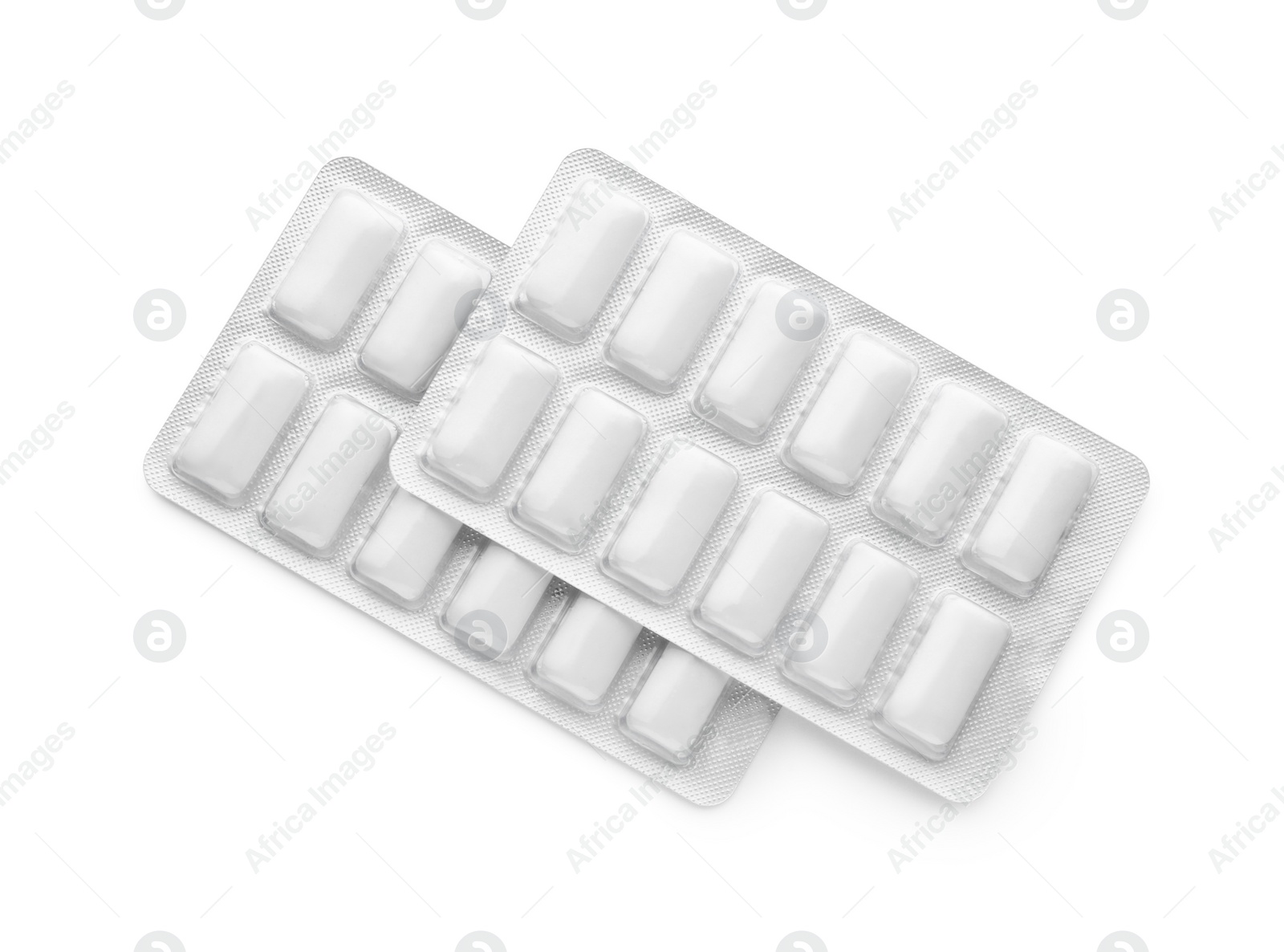 Photo of Blisters with chewing gums on white background, top view