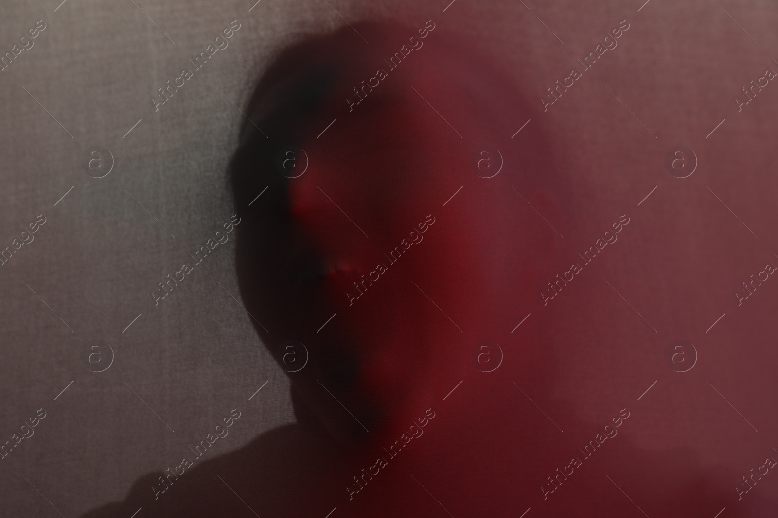 Photo of Silhouette of creepy ghost behind cloth, color toned