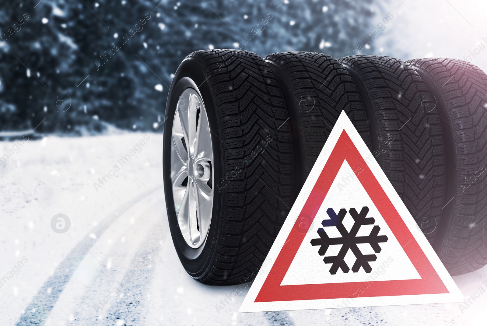 Image of Set of wheels with winter tires and road sign outdoors