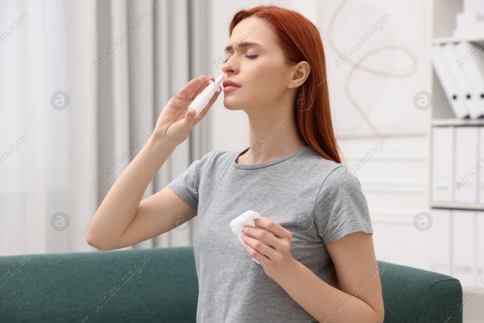 Photo of Medical drops. Woman using nasal spray at home